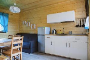 a kitchen with a refrigerator and a table in a room at Holiday resort, Wiselka in Wisełka