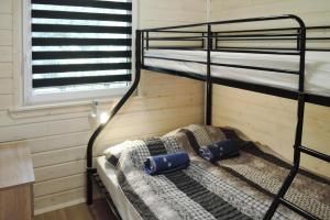 two bunk beds in a room with a window at Bungalow, Kolczewo in Kołczewo