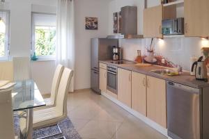 a kitchen with a table and a counter top at Large, comfortable holiday villa, private garden in Grzybowo