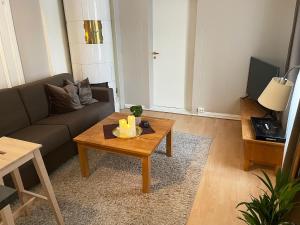 a living room with a couch and a coffee table at Finnegården Røros in Røros