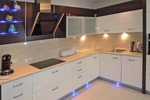 a kitchen with white cabinets and a christmas tree at Terraced house, Miedzyzdroje in Międzyzdroje