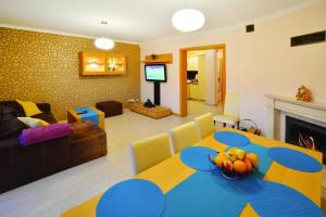 a living room with a blue table and a living room at Terraced House in Grzybowo near Beach in Grzybowo