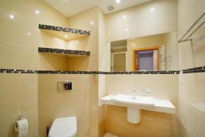 a bathroom with a sink and a toilet and a mirror at Terraced House in Grzybowo near Beach in Grzybowo +19 photos
