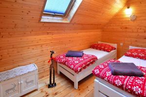 a room with two beds in a log cabin at holiday home, Ustronie Morskie in Ustronie Morskie