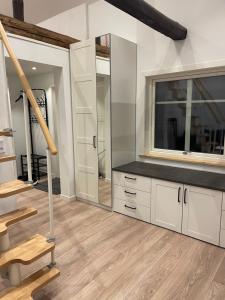 a living room with a staircase and a large mirror at Backes Lillstuga in Borlänge