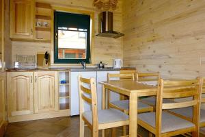 uma cozinha com uma mesa e cadeiras e um lavatório em Terraced Houses, Sarbinowo em Sarbinowo
