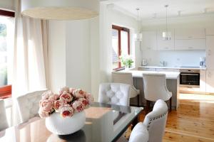 a living room with a glass table with a vase of flowers at Semi-detached house, Miedzyzdroje in Międzyzdroje