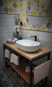 a bathroom with a large white sink on a counter at Prao del Molin in Cangas del Narcea
