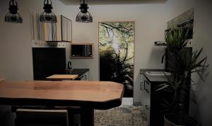 a kitchen with a wooden table and a dining room at Prao del Molin in Cangas del Narcea