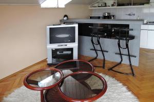 a kitchen with two red chairs and a television at holiday home in Stepnica in Stepnica