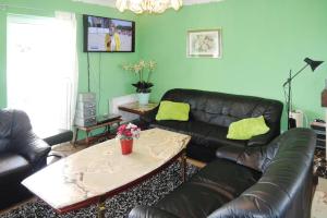 a living room with a leather couch and a table at holiday home, Nowe Warpno in Nowe Warpno