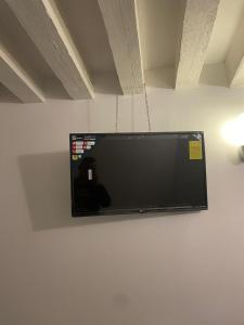 a flat screen tv hanging on a wall at Dimora Blu Suite in Venice