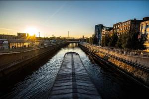 a river with a boat in the middle at H Bruxelles airport Charleroi Harmonie in Charleroi