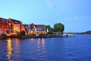 a boat is docked at a dock on a lake at Apartment lake view, Malchow in Malchow