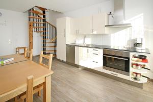 a kitchen with a table and a dining room at Apartment lake view, Malchow in Malchow