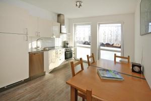 a kitchen with a wooden table and a wooden floor at Apartment lake view, Malchow in Malchow