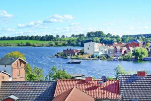 a view of a town with a river and houses at Apartment lake view, Malchow in Malchow