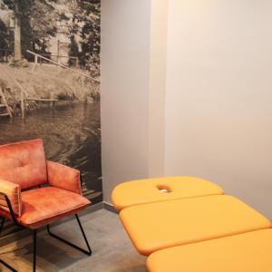 a chair and a stool in a room at Ratskeller Wiedenbrück in Rheda-Wiedenbrück