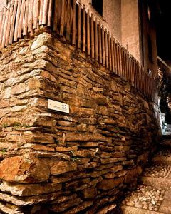 a stone wall with a fence on top of it at Residenza Valentino in Locarno +40 photos