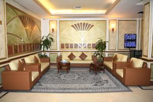 a lobby with couches and a flat screen tv at Continental Residence in Kuwait