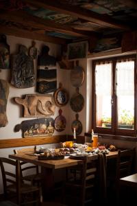 a dining room with a table with food on it at Agriturismo Bon Tajer in Colderù