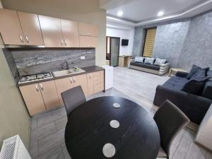 a kitchen and living room with a table and a couch at Cazare Gallamar in Bîrlad
