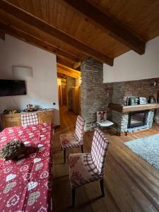 a living room with a table and chairs and a fireplace at Mansarda Belvedere in Scopello