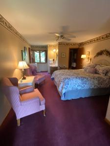 a bedroom with a bed and a couch and a chair at Pinehaven of Baraboo in Baraboo