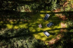 an overhead view of several televisions sitting in the grass at AMORZELAS in Dębki