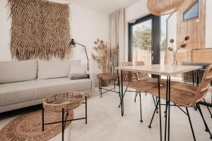 a living room with a couch and a table and chairs at AMORZELAS in Dębki +45 photos