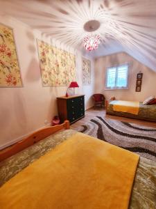 a bedroom with two beds and a ceiling at Chambres Dhôtes Numéro 1 in Châteaulin