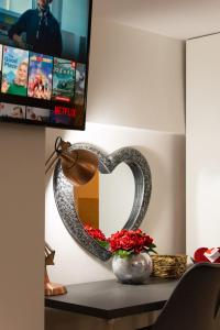 a heart shaped mirror on a table with a lamp at Dealhouse Apartments 1 in Huddersfield