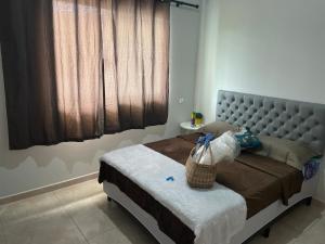 a bedroom with a bed with a basket on it at Flat hotel Victoram in Rio Branco