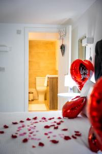 a room with a bed with red petals on the floor at Dealhouse Apartments 1 in Huddersfield