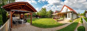 a backyard of a house with a gazebo at Pipacsos Vendégházak in Kiskunmajsa
