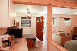 a kitchen and living room with a red door at Inn on the Russian River in Monte Rio