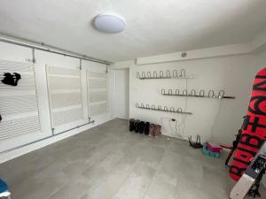 a room with white walls and a room with windows at Totina Apartments in Závažná Poruba