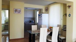 a kitchen and dining room with a table and chairs at Villa Byala Grape House in Byala
