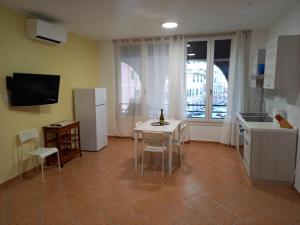 a kitchen with a table and chairs and a refrigerator at Domus Genuensis in Genoa