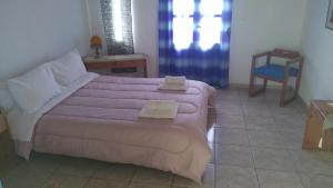 a bedroom with a large bed and a blue chair at Villas Irene 6 Family Apartments in Gournes