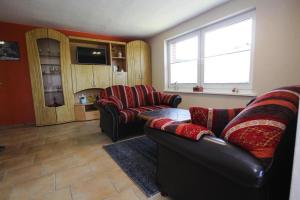 a living room with two couches and a window at Holiday home, Plau am See in Plau am See