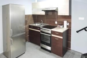 a kitchen with a stainless steel refrigerator and a sink at holiday home, Stepniczka in Stepnica