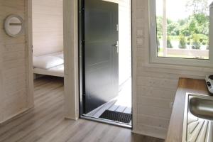 a room with a sliding glass door in a tiny house at Holiday complex, Kolczewo in Kołczewo