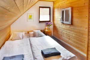 a bedroom with two beds in a wooden cabin at Holiday complex, Bobolin in Bobolin