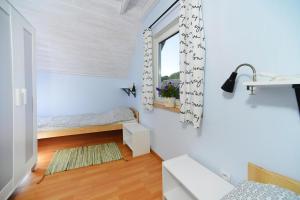 a small room with a bed and a window at Holiday homes, Rewal in Rewal