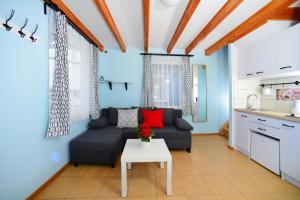 a living room with a couch and a table at Holiday homes, Rewal in Rewal