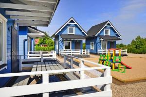 a house with a playground in front of it at Holiday homes, Rewal in Rewal