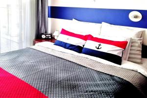 a bedroom with a bed with red white and blue at Holiday flat, Swinoujscie in Świnoujście
