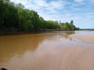 a view of a river with trees on the shore at Luz de las Sierras in Arroyo de Los Patos
