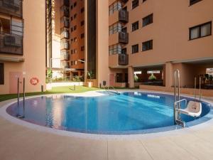a large swimming pool in the middle of a building at Apartment, Malaga in Málaga